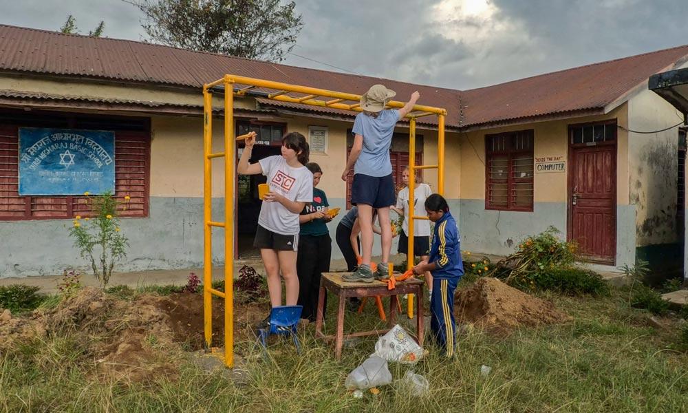 <i>Students painted the monkey bar after they had been erected on the ground.</i>