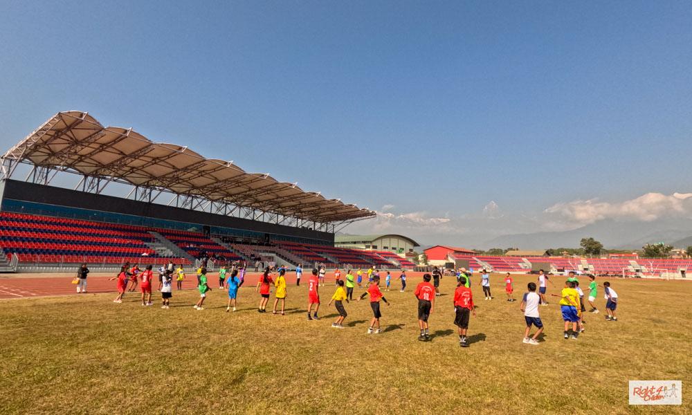 Participants are warming up before the competition, led by Right4Children's sports teachers, Nitu Tamang and Padam Kumari Sunuwar.