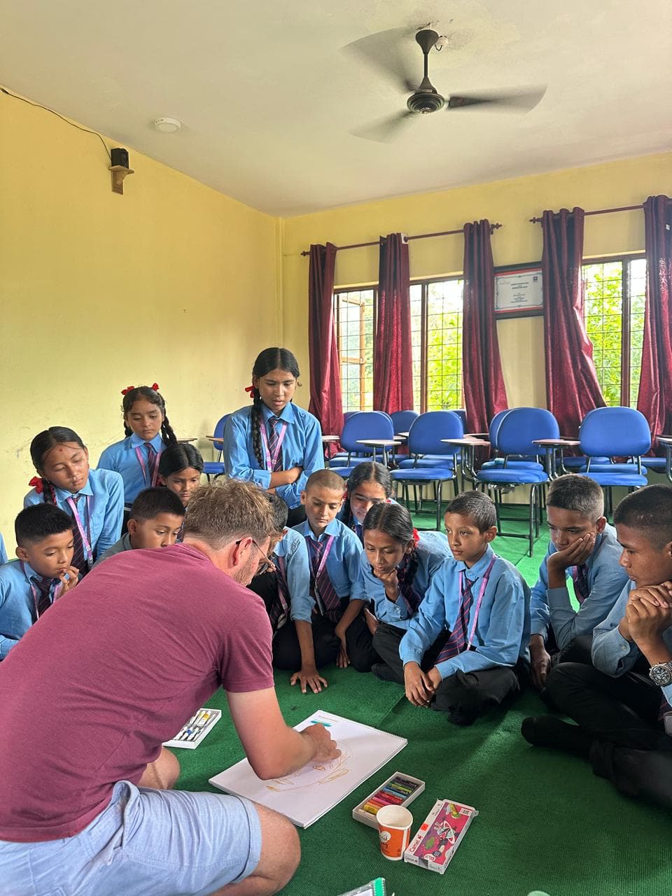 Gary teaching art to school students